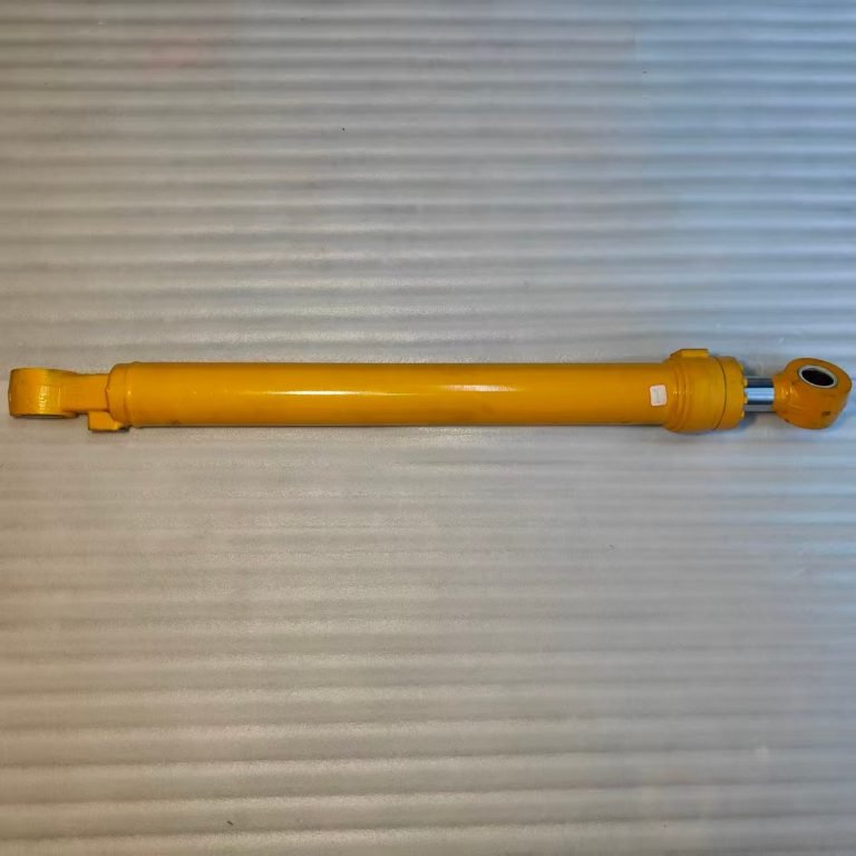 Yellow excavator bucket hydraulic cylinder with mounting eyes at both ends